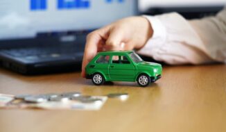Closeup shot of a person thinking of buying a new car or selling a vehicle